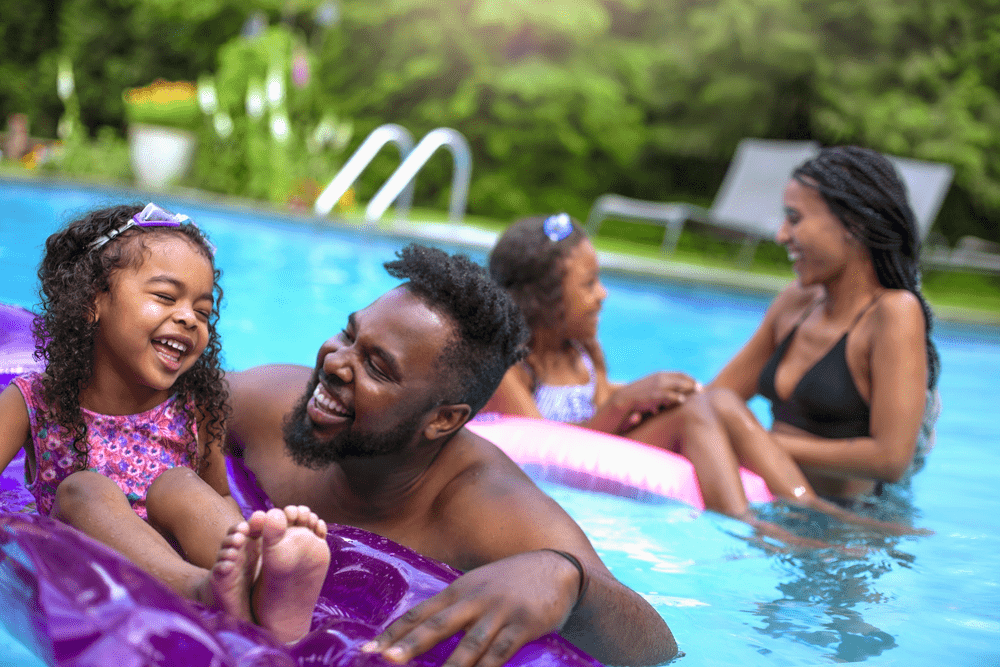 family playing in their pool