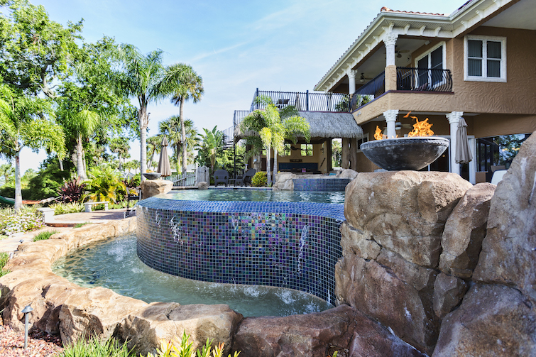 custom swimming pool water feature in backyard
